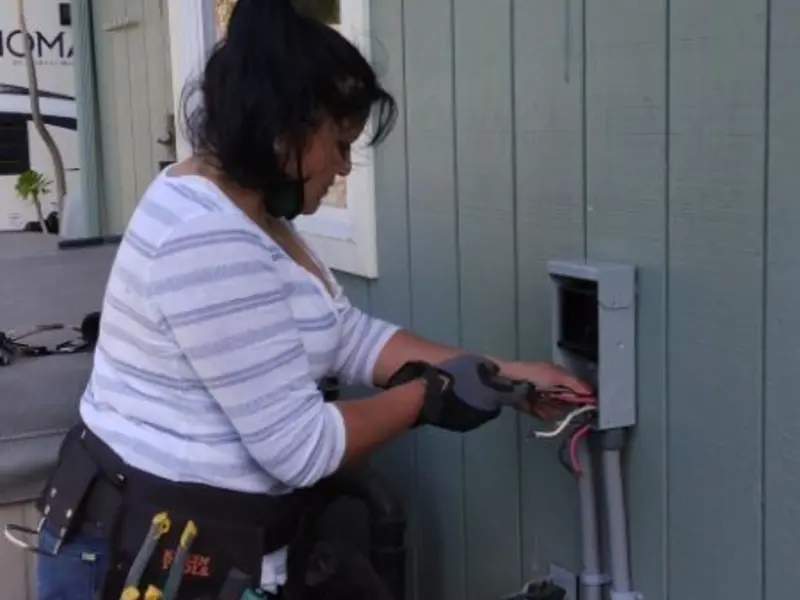 Licensed electrician wiring an exterior subpanel in Breese